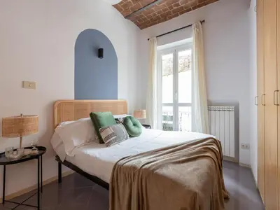 a bedroom with a bed and a window at The Best Rent - Two-bedroom apartment with terrace near Trevi Fountain in Rome