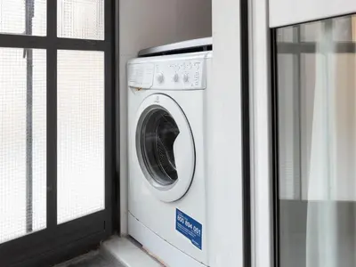 a washing machine sitting next to a window at The Best Rent - Two-bedroom apartment with terrace near Trevi Fountain in Rome