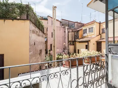 a balcony with a view of a city at The Best Rent - Two-bedroom apartment with terrace near Trevi Fountain in Rome