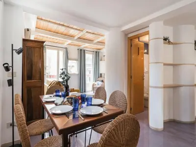 a dining room with a wooden table and chairs at The Best Rent - Two-bedroom apartment with terrace near Trevi Fountain in Rome