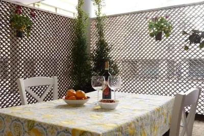 a table with a bottle of wine and a bowl of fruit at Casa Sofia Trastevere in Rome