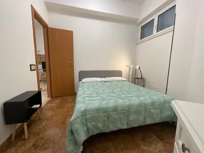 a bedroom with a bed with a green comforter at Casa Sofia Trastevere in Rome