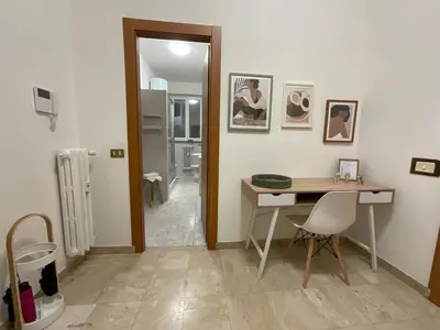a room with a desk and a table and chairs at Casa Sofia Trastevere in Rome