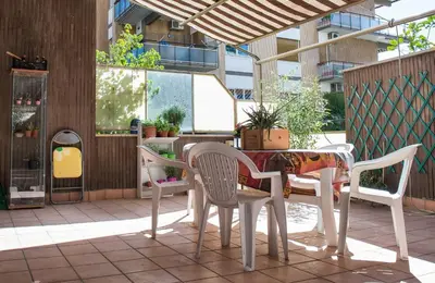 a table and chairs sitting on a patio at Appartamento con giardino via silvestri in Rome