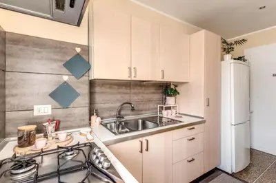 a kitchen with white cabinets and a sink at Rdd in Rome