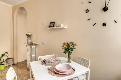 a dining room with a white table and chairs at Rdd in Rome