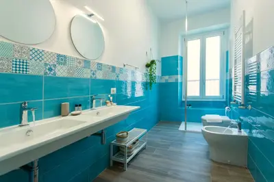 a blue and white bathroom with two sinks and a tub at Etta Suite - Close Vatican Museum in Rome