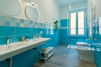 a blue bathroom with two sinks and a tub at Etta Suite - Close Vatican Museum in Rome