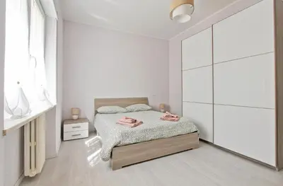 a white bedroom with a bed and a large closet at Martina Garden in Rome