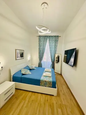 a bedroom with a bed and a window at Casa Vacanza Kambal in Rome