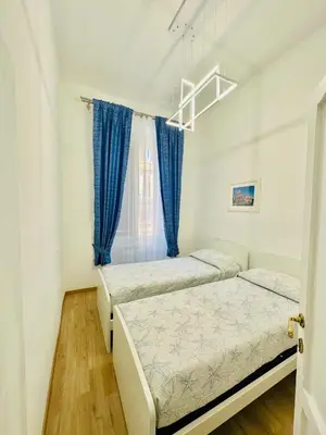 a bedroom with two beds and a window at Casa Vacanza Kambal in Rome