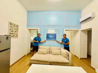 two men standing in a living room with a couch at Casa Vacanza Kambal in Rome