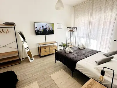 a bedroom with two beds and a flat screen tv at Baldo Family Apartment - Rome Collection in Rome