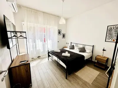 a bedroom with a bed and a table in it at Baldo Family Apartment - Rome Collection in Rome