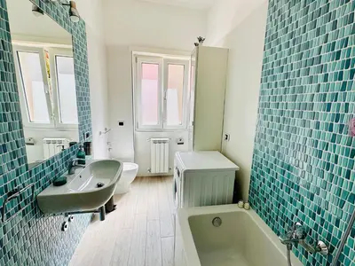 a bathroom with a tub and a sink and a toilet at Baldo Family Apartment - Rome Collection in Rome