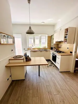 a large kitchen with a wooden table in it at Baldo Family Apartment - Rome Collection in Rome