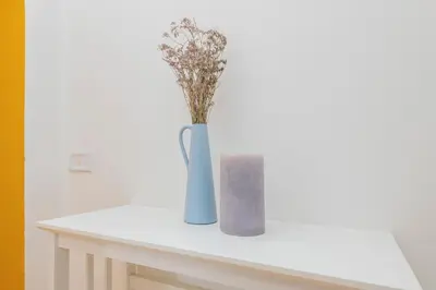 two vases sitting on a table with flowers in them at Colosseum Flat - ZEN23 in Rome