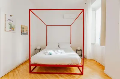 a bed with a canopy in a room at Colosseum Flat - ZEN23 in Rome