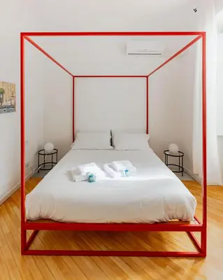 a bedroom with a canopy bed with two pillows at Colosseum Flat - ZEN23 in Rome