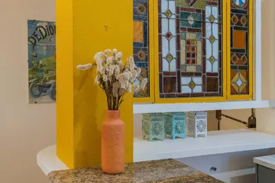 a vase with flowers in it sitting on a counter at Colosseum Flat - ZEN23 in Rome
