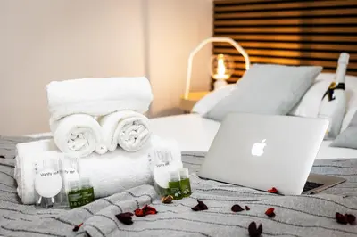 a bedroom with a bed with a laptop and towels at Dimora Pastini in Rome
