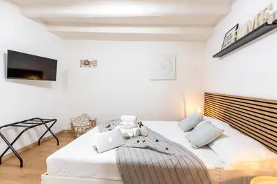 a bedroom with a bed with a laptop on it at Dimora Pastini in Rome