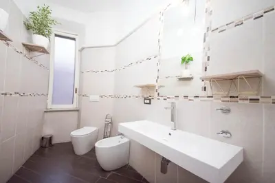 a white bathroom with a sink and a toilet at Tibullo House in Rome