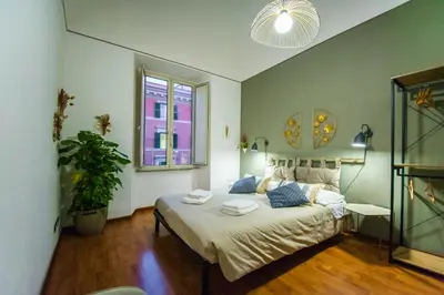 a bedroom with a bed with two towels on it at Tibullo House in Rome