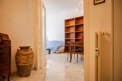 a room with a table and a vase next to a door at Fleming in Rome