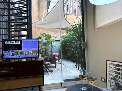 two wine glasses sitting on a table in front of a window at The shelter in Rome