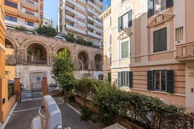 an alley in a city with tall buildings at Trastevere comfort 2 camere 2 bagni in Rome