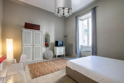 a bedroom with a bed and a tv and a window at Trastevere comfort 2 camere 2 bagni in Rome