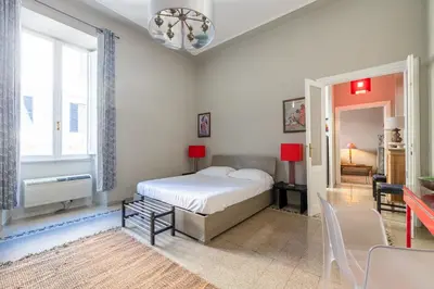 a bedroom with a bed and a table and chairs at Trastevere comfort 2 camere 2 bagni in Rome
