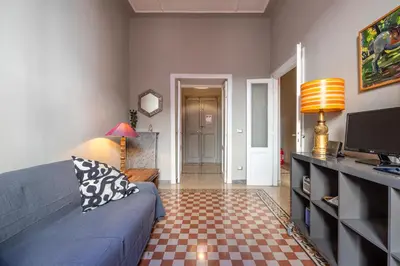 a living room with a blue couch and a television at Trastevere comfort 2 camere 2 bagni in Rome