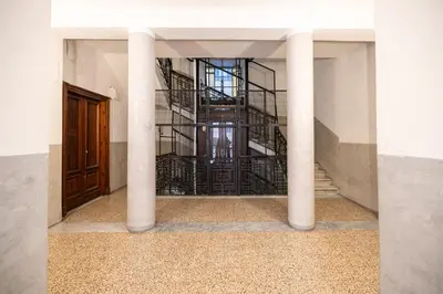 a staircase in a building with columns and a door at Trastevere comfort 2 camere 2 bagni in Rome