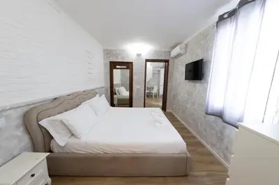 a bedroom with a bed and a television in it at Domus Augustea - 2 Floor in Rome