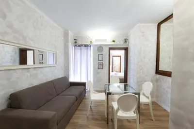 a living room with a couch and a table at Domus Augustea - 2 Floor in Rome