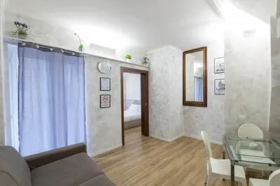 a living room with a couch and a glass table at Domus Augustea - 2 Floor in Rome