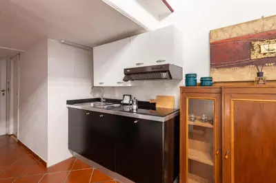 a kitchen with a black and white kitchen at Sweet Rhome Navona Loft Centro Storico in Rome