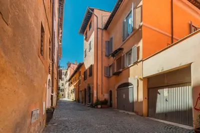 an alley in an old town with orange buildings at Sweet Rhome Navona Loft Centro Storico in Rome