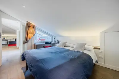 a bedroom with a large bed and a desk at Casa Doni Roma in Rome