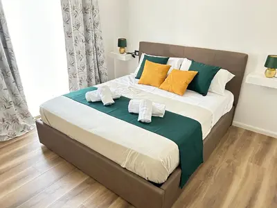 a bedroom with a large bed with towels on it at House of Wonders in Rome
