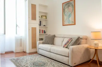 a living room with a couch and a table at Casa Novecento Prati in Rome