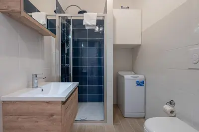 a bathroom with a sink and a toilet and a shower at Casa Novecento Prati in Rome