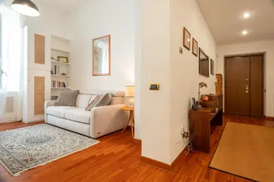 a living room with a couch and a table at Casa Novecento Prati in Rome