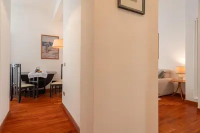 a hallway leading into a living room with a table at Casa Novecento Prati in Rome