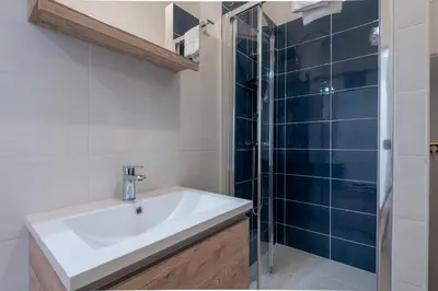 a bathroom with a sink and a shower at Casa Novecento Prati in Rome