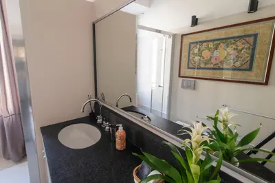 a bathroom with a sink and a large mirror at Il Clivo in Rome