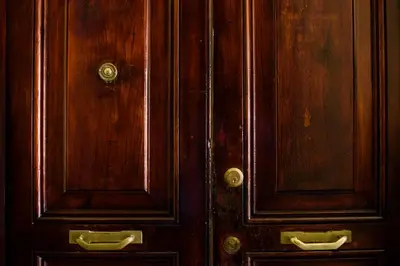 a pair of wooden doors with metal pulls at Il Clivo in Rome