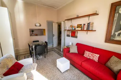 a living room with a red couch and a table at Il Clivo in Rome